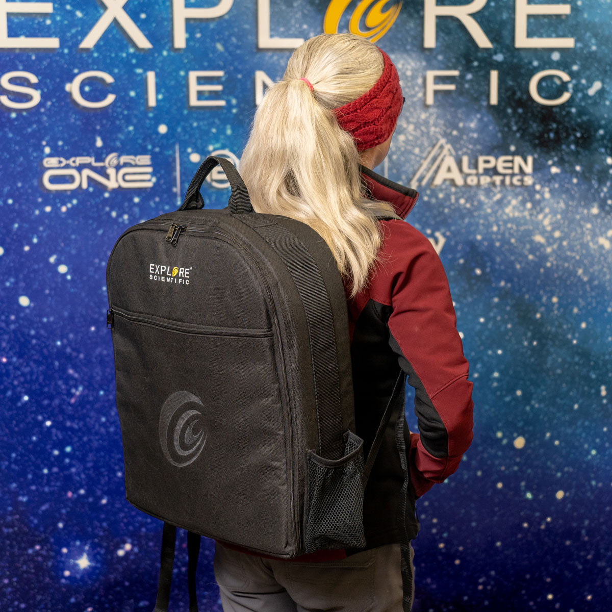 The backpack case packed with a small refractor and accessories inside its divided compartments